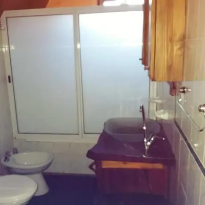 a bathroom with a sink and a toilet at Cabañas atardecer soñado in Villa Yacanto