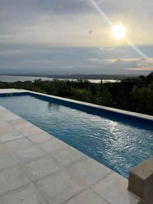 a swimming pool with a view of the ocean at Complejo DOS LUNAS in La Porteña