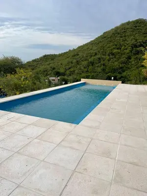 a swimming pool with a mountain in the background at Complejo DOS LUNAS in La Porteña