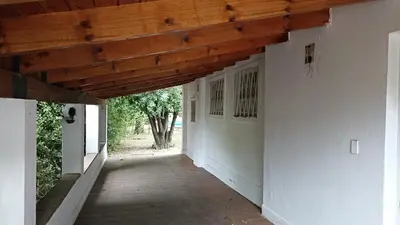 an empty hallway of a house with a wooden ceiling at Casa con pileta y jardín - 3 dormitorios in Villa Carlos Paz