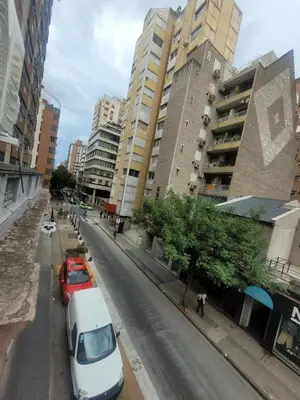 a street with cars parked on the side of the road at Departamento RONDEAU, NUEVA CÓRDOBA in Cordoba