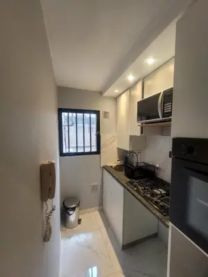 a small kitchen with a counter and a phone at Departamento RONDEAU, NUEVA CÓRDOBA in Cordoba