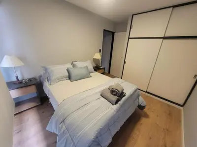 a bedroom with a bed with a teddy bear on it at Departamento RONDEAU, NUEVA CÓRDOBA in Cordoba