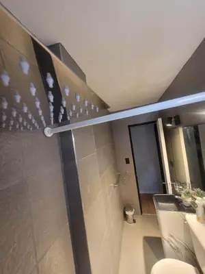 a bathroom with a shower with a toilet and a sink at Departamento RONDEAU, NUEVA CÓRDOBA in Cordoba