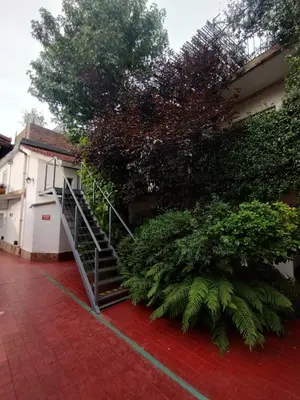 a staircase leading up to a building with plants at Nuevo Chalet Suizo in Villa Carlos Paz