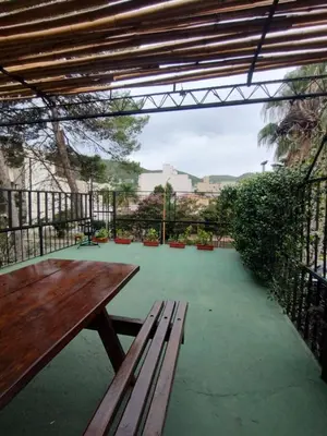 a wooden bench sitting on top of a patio at Nuevo Chalet Suizo in Villa Carlos Paz