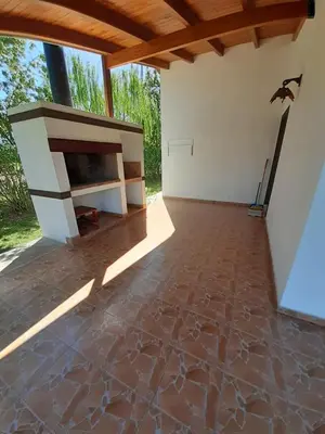 an empty room with a fireplace and a bird on the wall at LA TORRE - Complejo de cabañas in Villa Rumipal