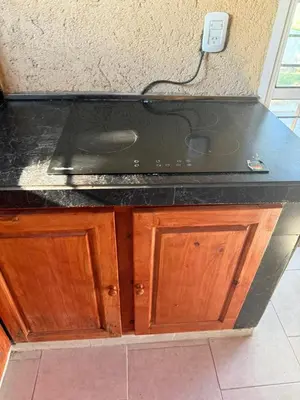 a kitchen counter with a stove on top of it at Hermosa Casa en Mirador del Lago - Bialet Masse in Bialet Massé
