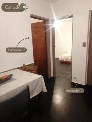 a room with a table and a room with a bed at Departamento dos habitaciones en zona tranquila in Cordoba
