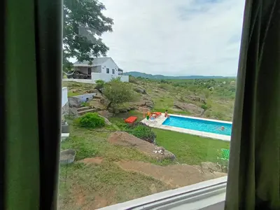 a view of a swimming pool from a window at Xaraba in Villa Parque Siquiman