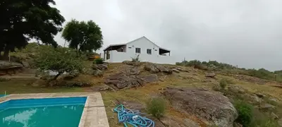 a house on top of a hill with a swimming pool at Xaraba in Villa Parque Siquiman