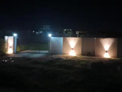 two lights on the side of a building at night at Xaraba in Villa Parque Siquiman