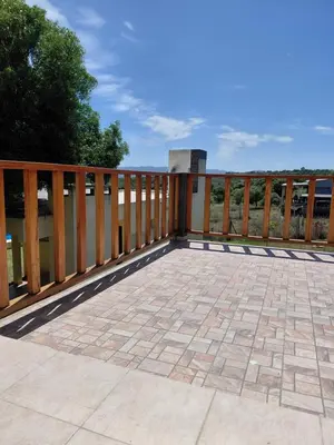 a deck with a wooden fence and a patio at Mi Destino in Tanti