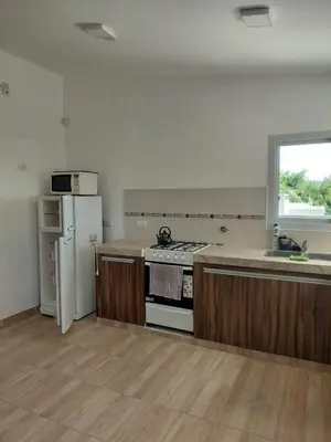 an empty kitchen with a stove and a refrigerator at Mi Destino in Tanti
