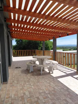 a wooden pergola with a picnic table on a patio at Mi Destino in Tanti