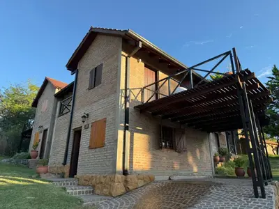 a large brick building with a wooden roof at Cabañas El Mirador in Alpa Corral