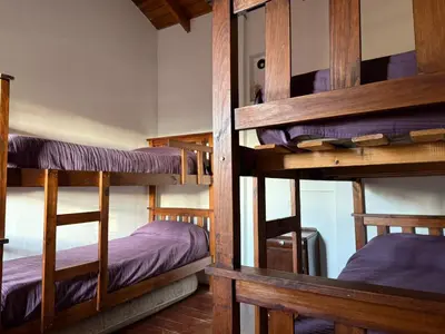 a room with three bunk beds in a room at Cabañas El Mirador in Alpa Corral