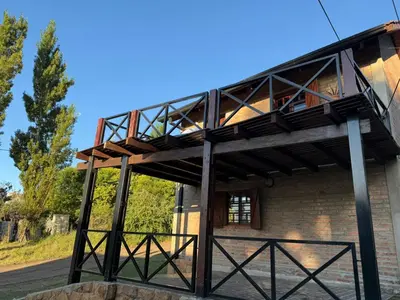 a building with a balcony on the side of it at Cabañas El Mirador in Alpa Corral