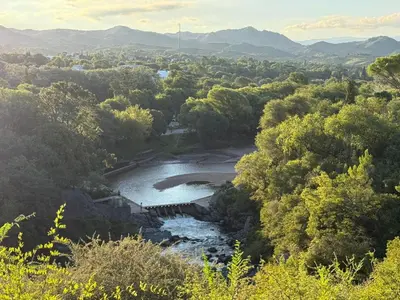 an aerial view of a river with trees and mountains at Cabañas El Mirador in Alpa Corral