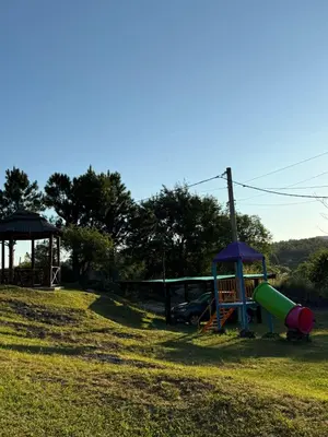 a park with a playground with a slide and a slideintend at Cabañas El Mirador in Alpa Corral