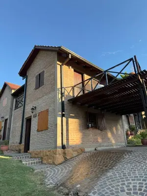 a large brick building with a balcony on the side at Cabañas El Mirador in Alpa Corral