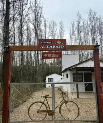 a bike is parked in front of a sign at AlCarajo in Villa Yacanto
