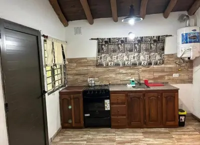 a kitchen with a stove and a counter top at AlCarajo in Villa Yacanto