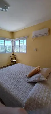 a bedroom with a large bed with two pillows on it at El Mirador de la Finca in Cavalango