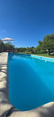a large swimming pool with blue water at El Mirador de la Finca in Cavalango