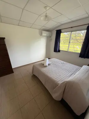 a bedroom with a bed with two towels on it at Cabañas Marquetti 2 in Potrero de Garay
