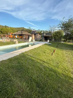 a yard with a swimming pool and a house at Cabañas Marquetti 2 in Potrero de Garay