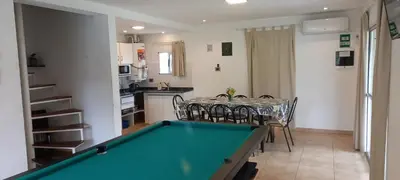 a dining room with a pool table and a kitchen at El Campito in San Antonio de Arredondo