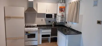 a kitchen with white cabinets and a counter top at El Campito in San Antonio de Arredondo