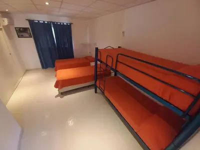 a room with two bunk beds and a window at El Campito in San Antonio de Arredondo