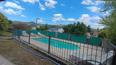 a fence with a pool in a yard at La Casita de Daniel in San Antonio de Arredondo