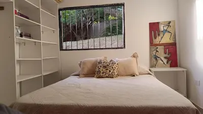 a bedroom with a bed with a window at La Casita de Daniel in San Antonio de Arredondo
