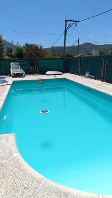 a large swimming pool with blue water in a yard at La Casita de Daniel in San Antonio de Arredondo