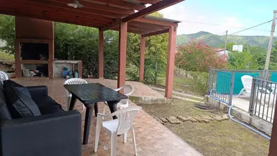a patio with a black table and white chairs at La Casita de Daniel in San Antonio de Arredondo