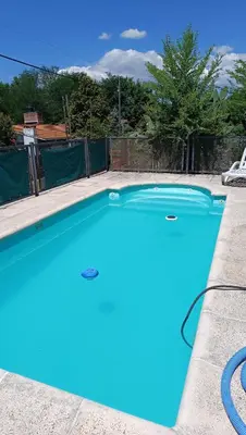 a large blue swimming pool in a yard at La Casita de Daniel in San Antonio de Arredondo