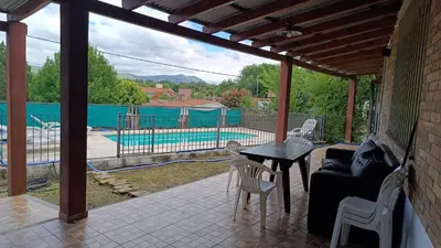 a patio with a table and chairs and a pool at La Casita de Daniel in San Antonio de Arredondo