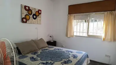 a bedroom with a bed and a window at La Casita de Daniel in San Antonio de Arredondo
