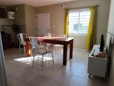 a dining room with a wooden table and chairs at Solo empresas mensual in Pilar