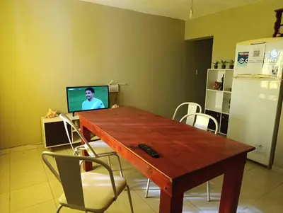 a kitchen with a wooden table with a television on it at Solo empresas mensual in Pilar