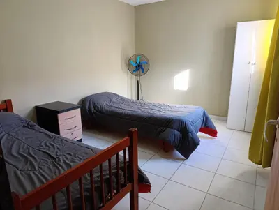 a bedroom with two beds and a fan at Solo empresas mensual in Pilar