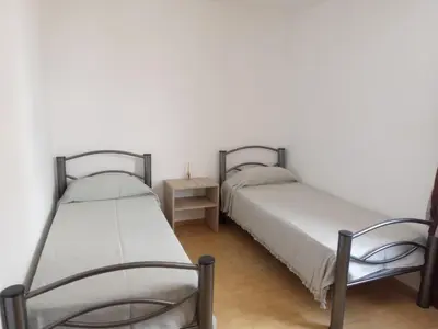 two beds sitting next to each other in a room at Luminoso in Villa Carlos Paz