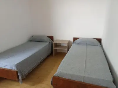a bedroom with two beds and a night stand at Luminoso in Villa Carlos Paz