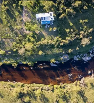 an aerial view of a rv parked on the side of a river at La Vision, Casa de campo in Villa Quillinzo