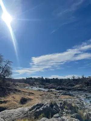 a sun is shining over a field with rocks at La Vision, Casa de campo in Villa Quillinzo