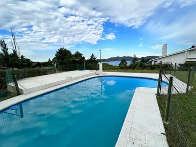 a swimming pool with blue water in a yard at Mar y Mar in La Estancia