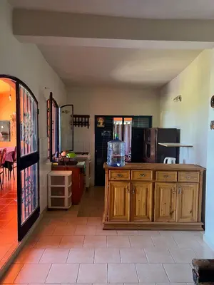 a kitchen with wooden cabinets and a table at Mar y Mar in La Estancia